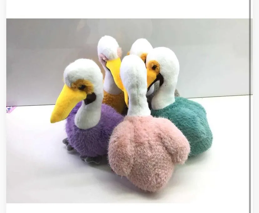 Design & Features: Each bird plushie features an upright white plush neck and head, a bright yellow beak with tan accent patches around the eyes, dark plastic safety eyes, and grey webbed feet at the base