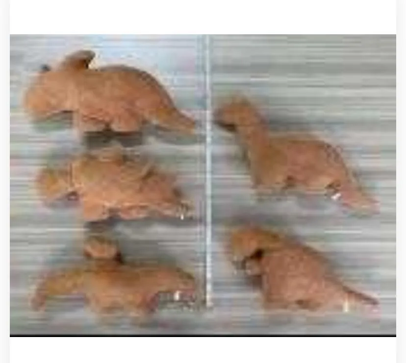 collection of five brown dinosaur-shaped plush toys arranged on a light grey background, designed to resemble chicken nuggets (dino nuggets