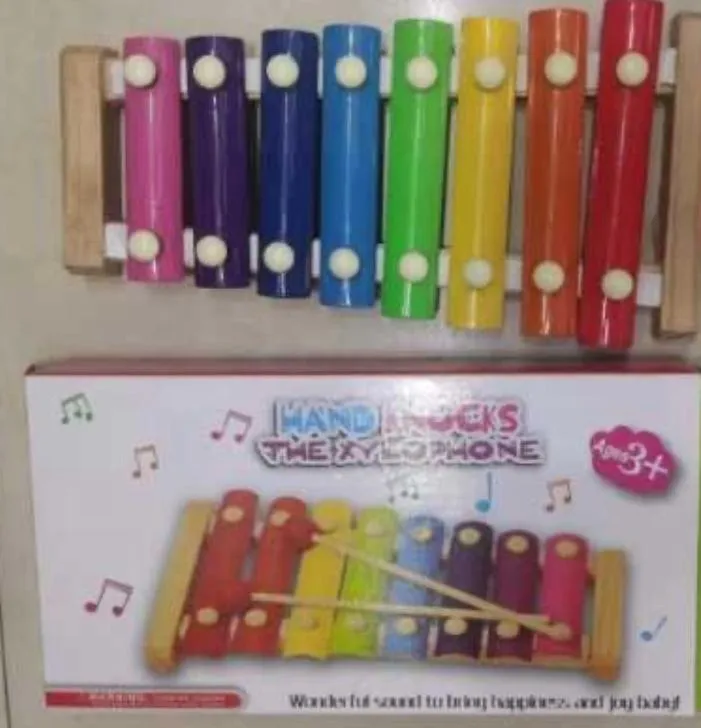 Features 8 vibrant, color-coded metal/wooden sound bars set on a light wooden frame, helping children recognize notes through color association