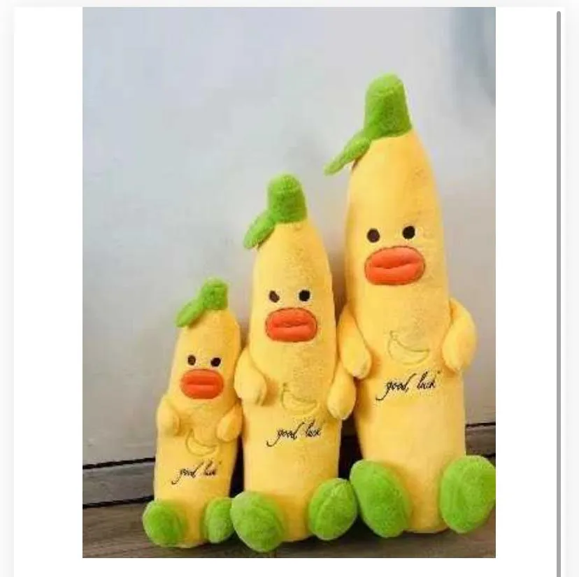 three banana duck plush body pillows arranged in ascending order by size against a plain white wall.