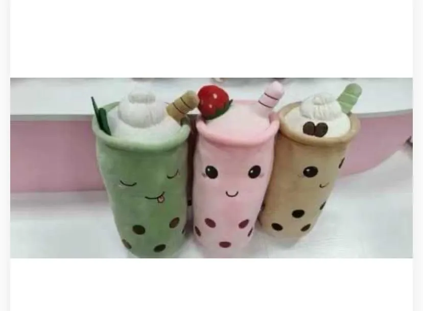 Features sleeping closed eyes, a small tongue sticking out, whipped cream on top with a green leaf accent, and a brown straw.