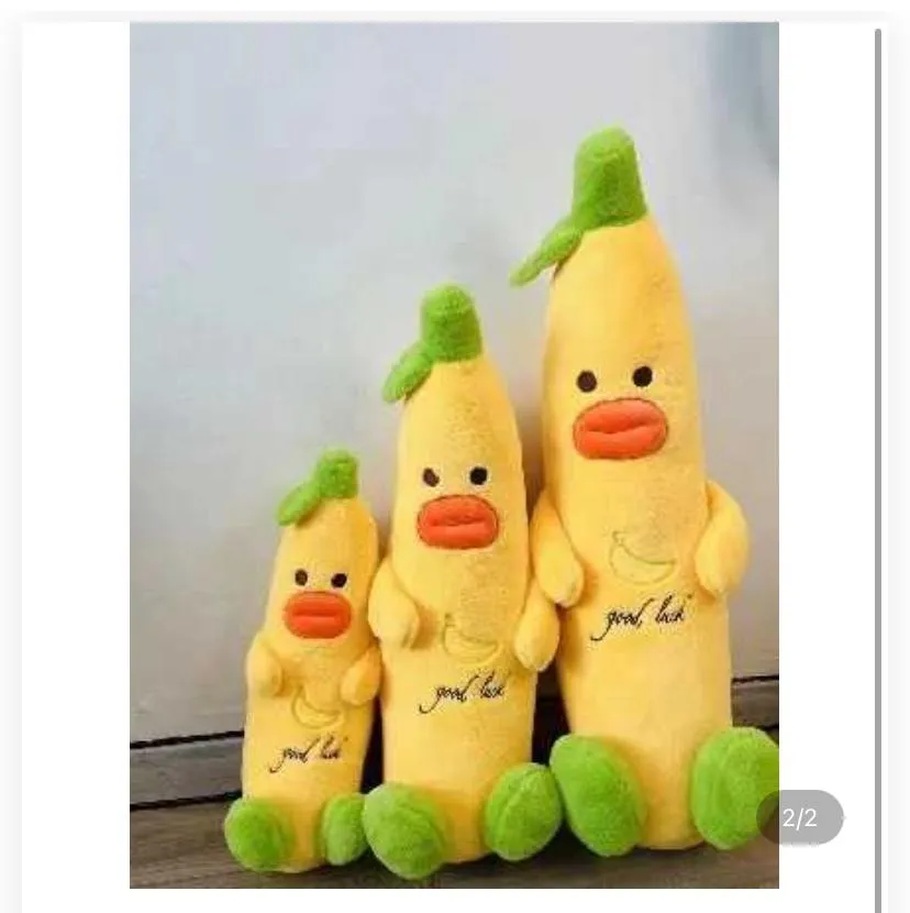 three banana duck plush body pillows arranged in ascending order by size against a plain white wall.