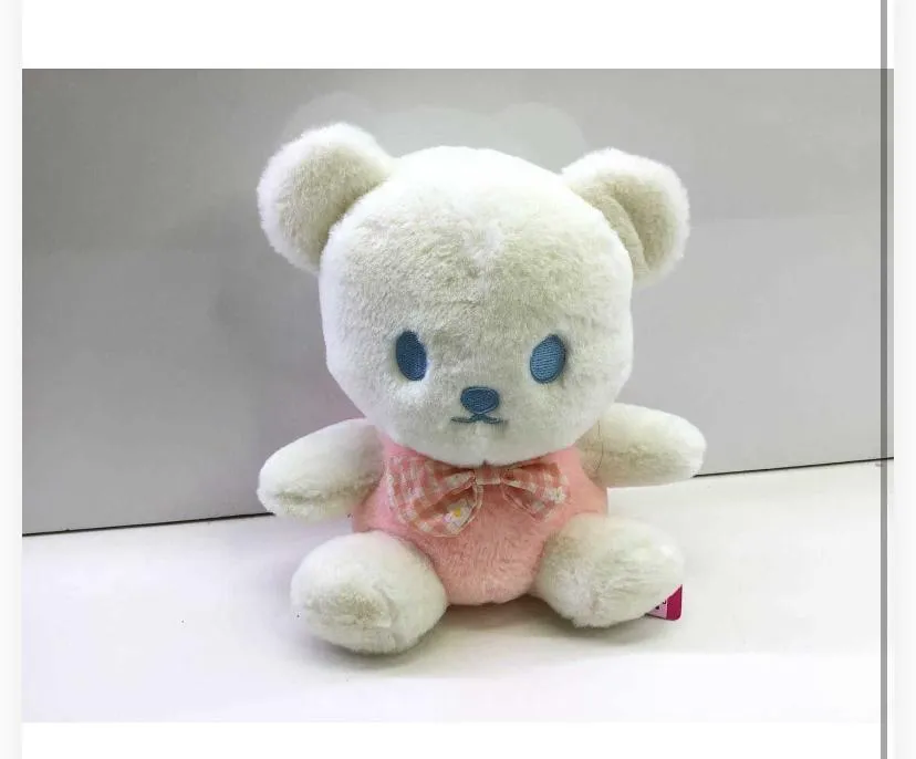 This image features a seated teddy bear plush toy posed on a white surface.